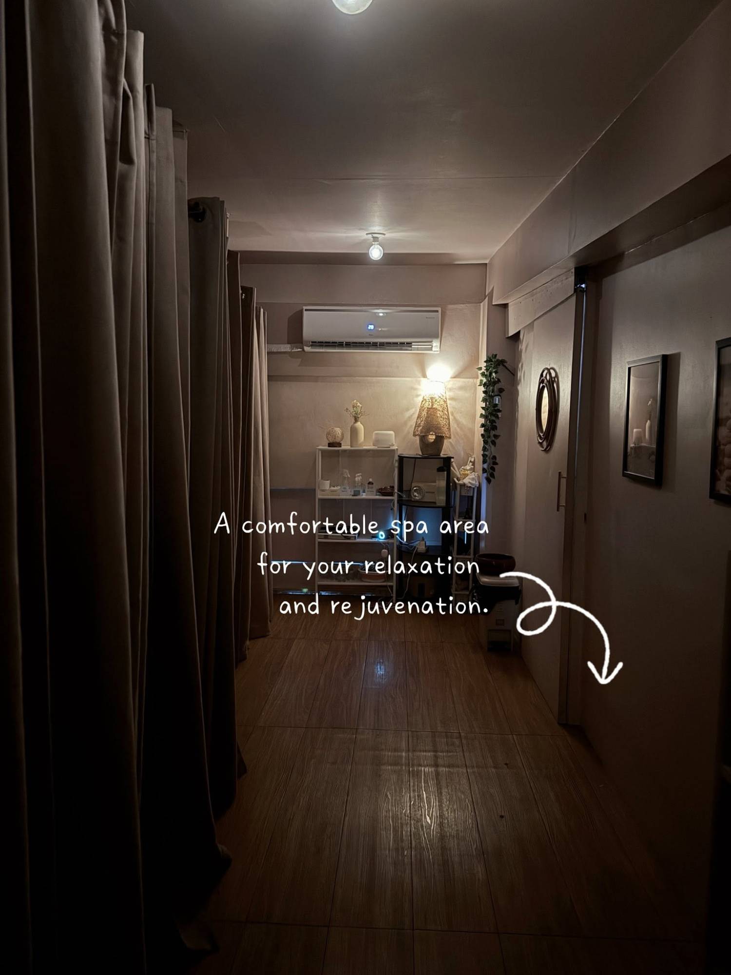 Softly lit spa corridor with curtained treatment rooms
